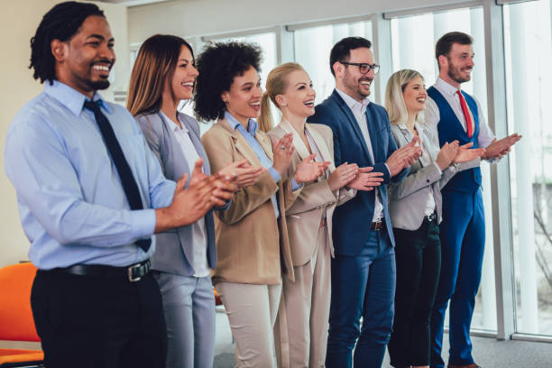 istock Group of businesspeople clapping in office. 1139110497