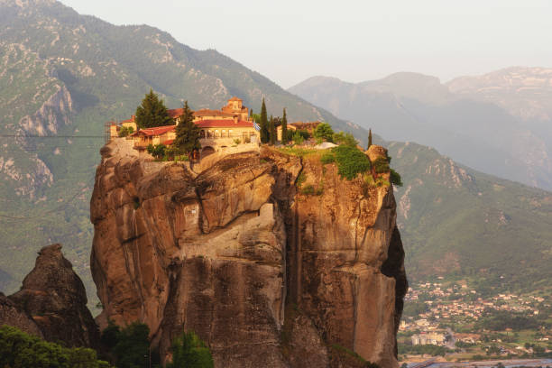 istock Monastery Holy Trinity, Meteora, Greece. UNESCO world heritage Site. Epic spring landscape with temple at the edge of cliff at dramatic sky background. 1139110769