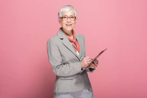 istock Old business woman with digital tablet 1139111529