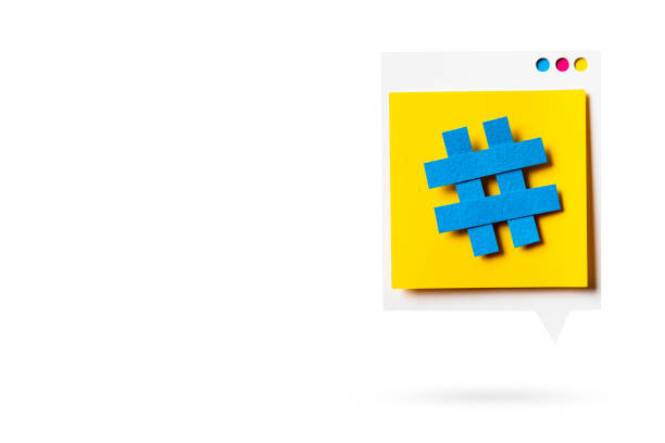 Paper cutout of hashtag symbol on a yellow speech bubble isolated. Concept of social media and digital marketing. stock photo