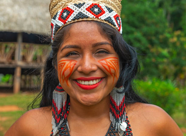 Embera Indigenous Woman Portrait, Panama Portrait of a smiling indigenous Embera woman in her village inside the rainforest of Panama. The Embera tribes can be found in the Darien jungle of Panama and Colombia as well as along the Panama Canal. american tribal culture stock pictures, royalty-free photos & images