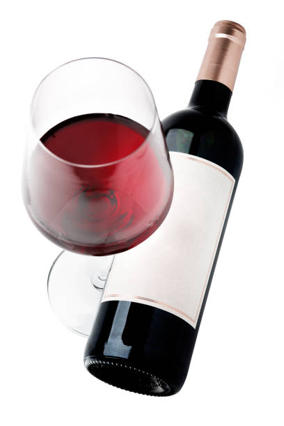 istock Red wine bottle and glass, with real paper blank label. Isolated on white 1139113159