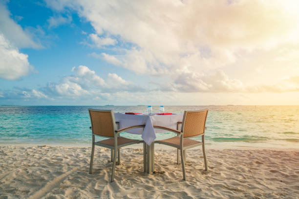 istock Table outdoor next to sea scenic prepare for special romantic dinner time. 1139113348