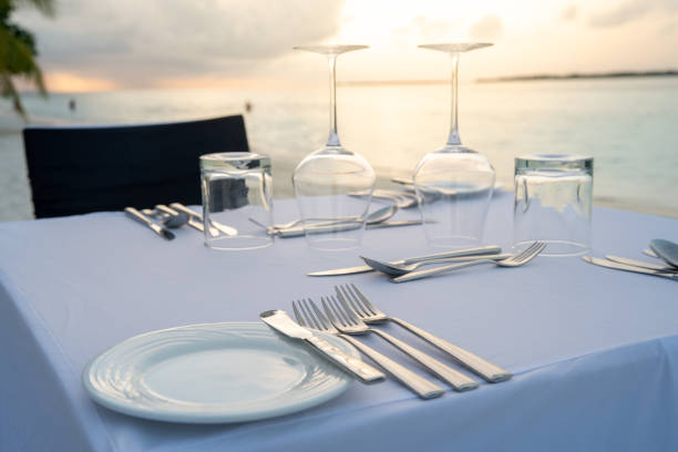 istock Table outdoor next to sea scenic prepare for special romantic dinner time. 1139113351