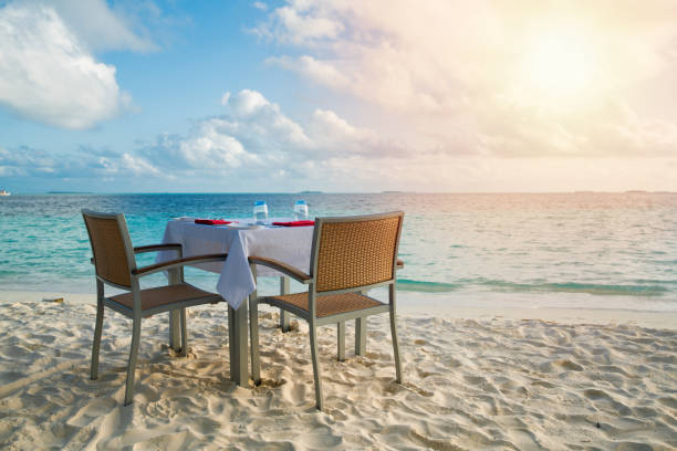 istock Table outdoor next to sea scenic prepare for special romantic dinner time with sunlight shading 1139113352