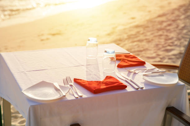 istock Table outdoor next to sea scenic prepare for special romantic dinner time with sunlight shading 1139113356