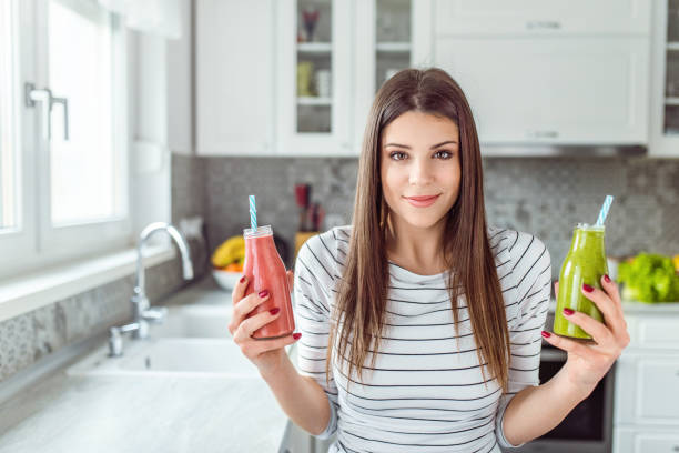 istock Hesitating Woman Thinking about which of smoothies should drink. 1139113404
