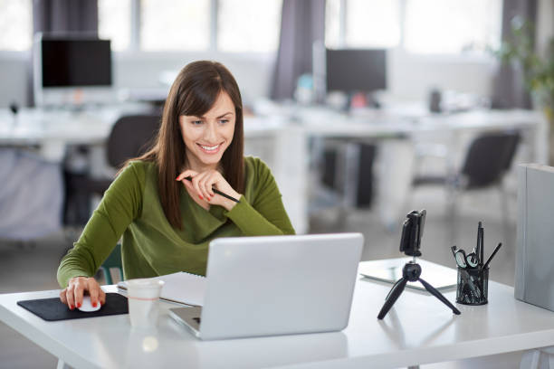 Woman using laptop in office. stock photo