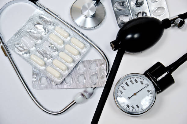 istock phonendoscope and tonometer  with a folder with white sheets of paper and pills  on a white background 1139117727