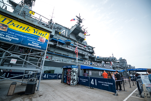 San Diego, USA - January 06, 2018:  USS Midway Museum in San Diego Harbour  with tourists entering the ship for sightseeing.