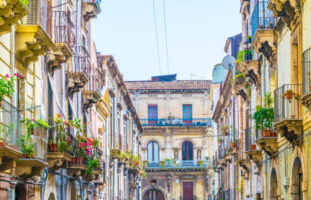 View of a narrow street in Catania, Sicily, Italy View of a narrow street in Catania, Sicily, Italy store wall surrounding wall facade stock pictures, royalty-free photos & images