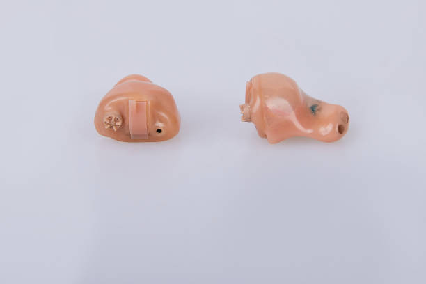 istock hearing aids on white background, alternative to surgery 1139123126