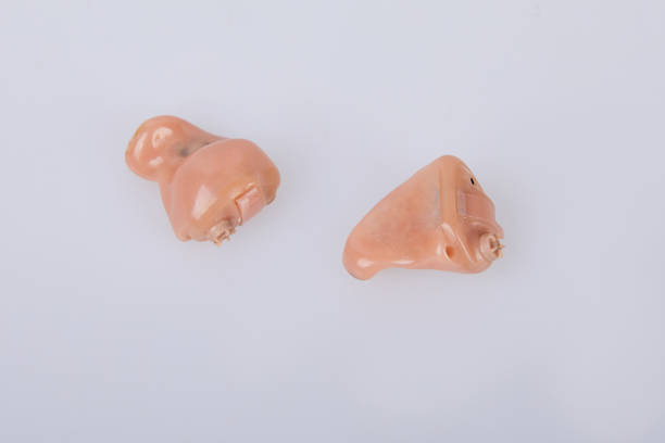 istock hearing aids on white background, alternative to surgery 1139123136