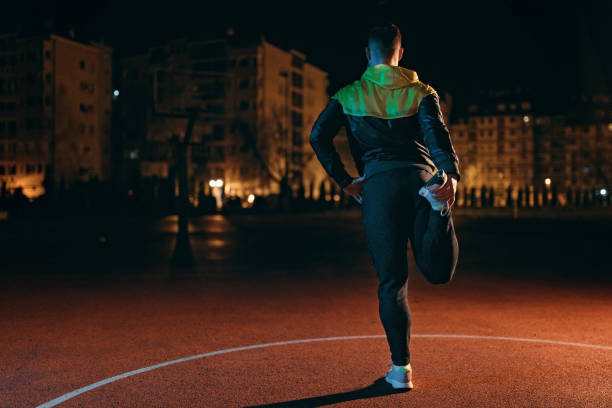istock Athletic young man stretching outdoors at night. 1139123843