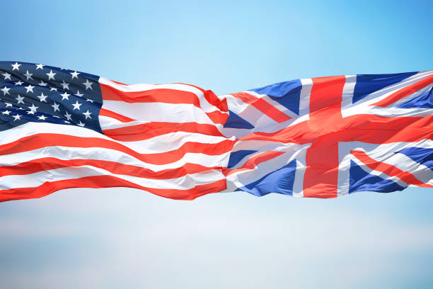 Flags of the USA and Great Britain against the background of the blue sky