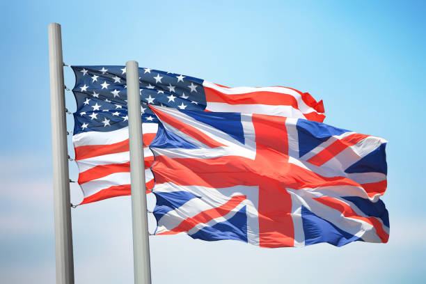 Flags of Great Britain and the USA against the background of the blue sky