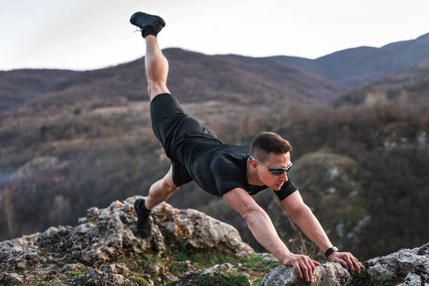 istock Athletic young man exercising on a mountain. 1139124915