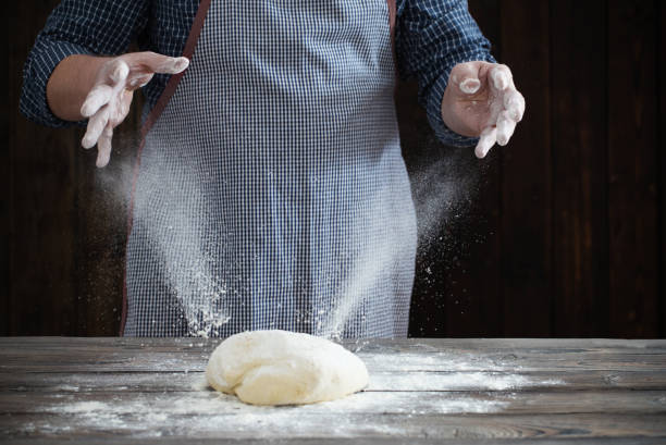 istock hands cooking dough on dark wooden background 1139125012