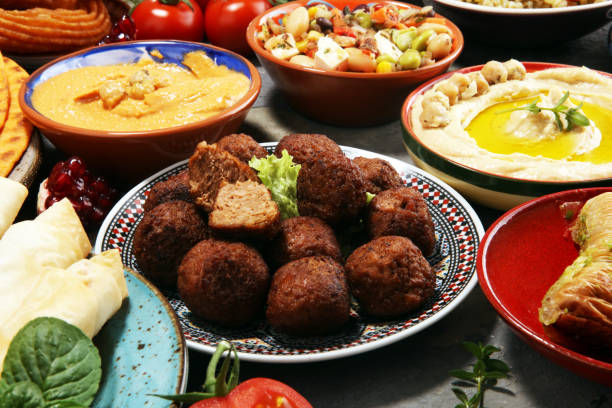 istock Middle eastern or arabic dishes and assorted meze, concrete rustic background. Falafel. Turkish Dessert Baklava with pistachio. Halal food. Lebanese cuisine 1139127234