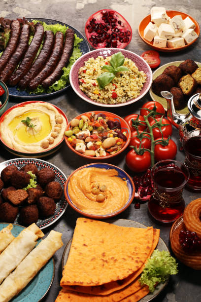 istock Middle eastern or arabic dishes and assorted meze, concrete rustic background. Falafel. Turkish Dessert Baklava with pistachio. Halal food. Lebanese cuisine 1139128162
