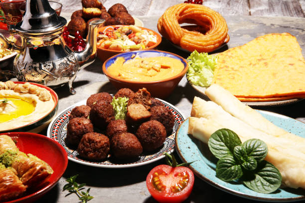 istock Middle eastern or arabic dishes and assorted meze, concrete rustic background. Falafel. Turkish Dessert Baklava with pistachio. Halal food. Lebanese cuisine 1139128365