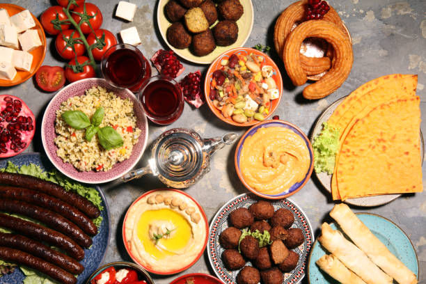 istock Middle eastern or arabic dishes and assorted meze, concrete rustic background. Falafel. Turkish Dessert Baklava with pistachio. Halal food. Lebanese cuisine 1139128425