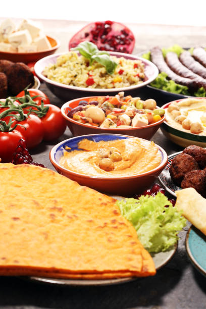 istock Middle eastern or arabic dishes and assorted meze, concrete rustic background. Falafel. Turkish Dessert Baklava with pistachio. Halal food. Lebanese cuisine 1139128820