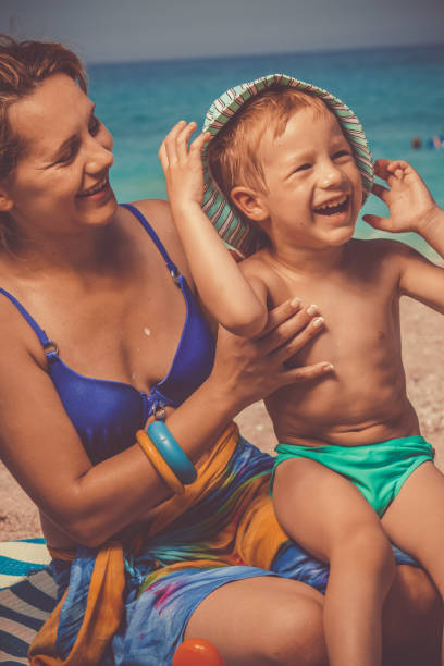 istock Smiling boy with his mother at the beach 1139130283