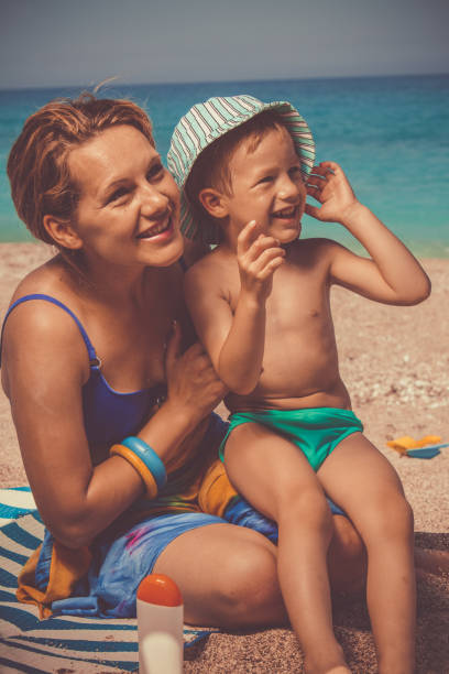 istock Smiling boy with his mother at the beach 1139130287