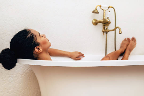 istock Female relaxing in bathtub with eyes closed 1139130605