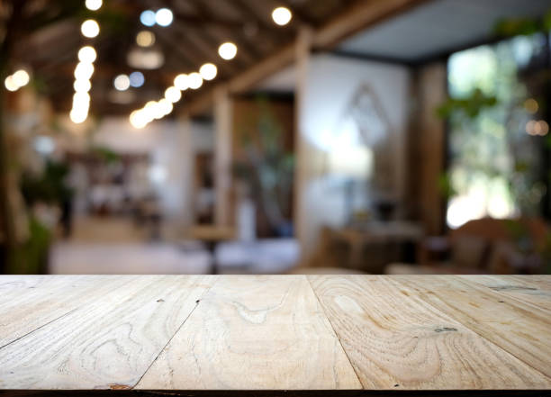 wood table on blur of cafe, coffee shop, bar, resturant, background - can used for display or montage your products stock photo