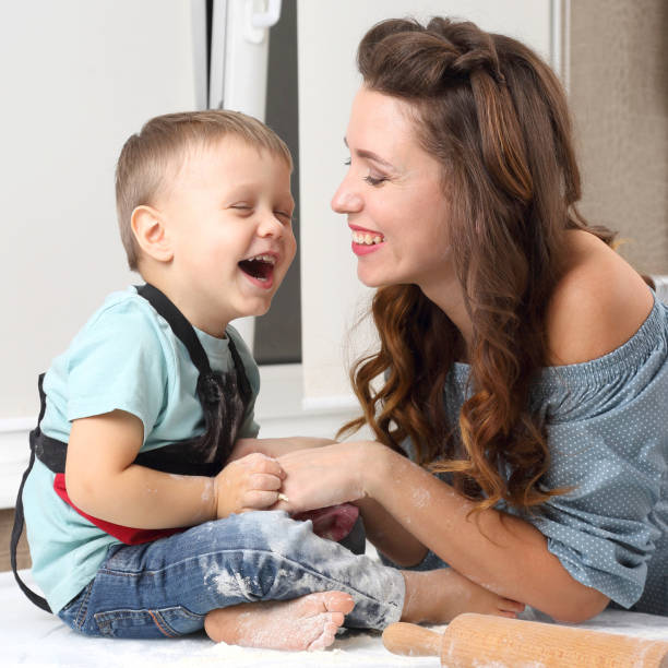 istock mother and baby laugh while preparing dough in the kitchen 1139133168