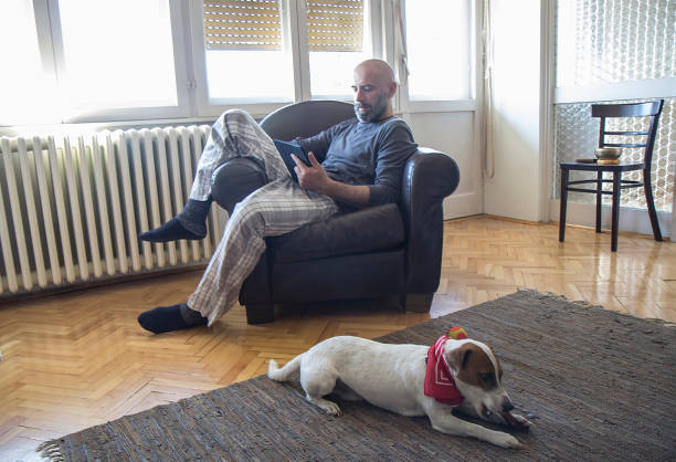 istock Man with a dog at home 1139133602