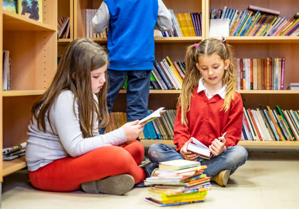 istock Schoolchildren sitting and reading in library 1139142261