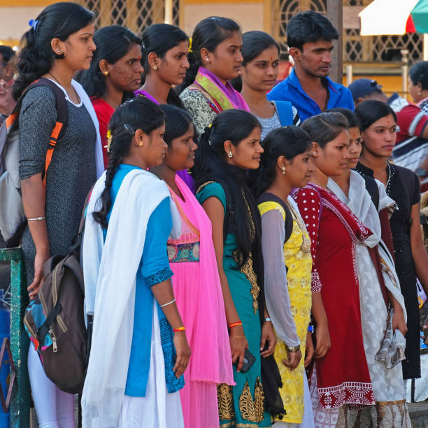 Mysore, India - March 3, 2018: A group of young pilgrims pose for a photograph outside the Shri Chanundeshwari Hindu temple on the outskirts of the city