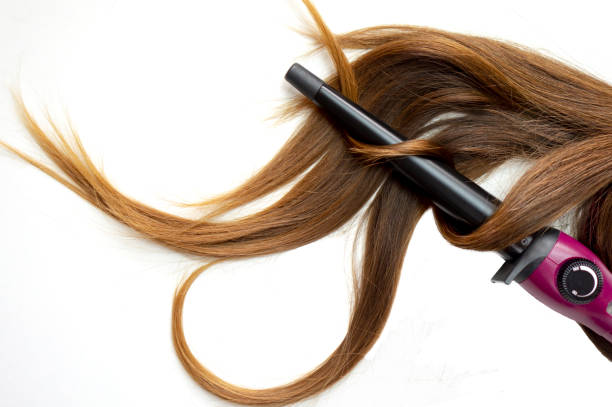 istock long brown curly hair on white isolated background with curling iron 1139142860