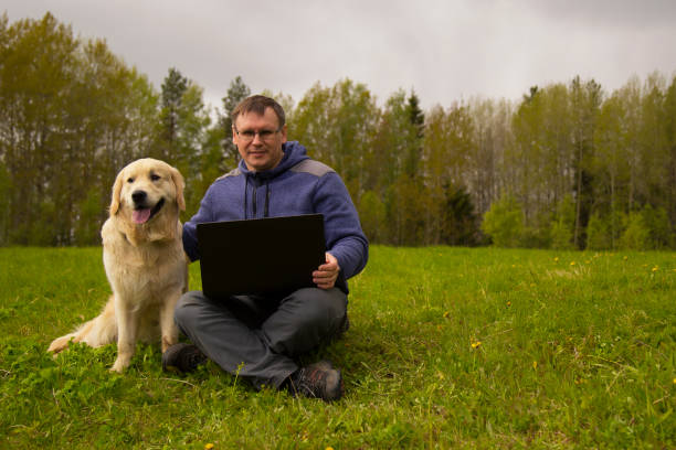 istock laptop and man and dog 1139144201