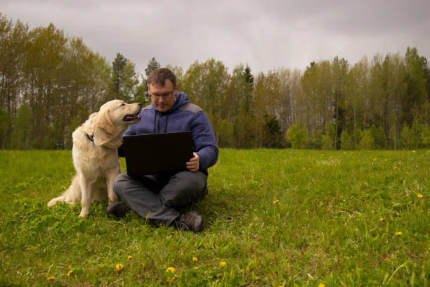 istock laptop and man and dog 1139144203