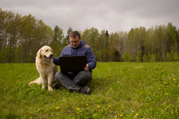 istock laptop and man and dog 1139144214