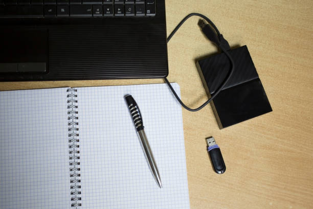 istock Concept. Office work. Laptop, hard drive,glasses , pen, notebook, flash drive 1139144906