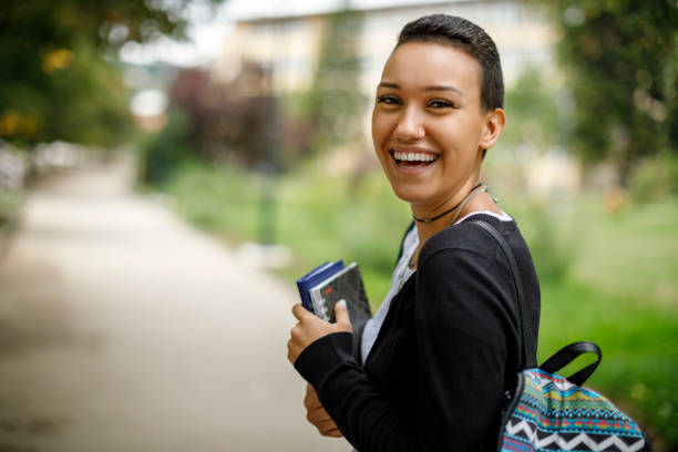 istock Happy female college student with books on university campus 1139145095