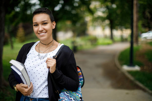 istock Happy female college student with books on university campus 1139145283