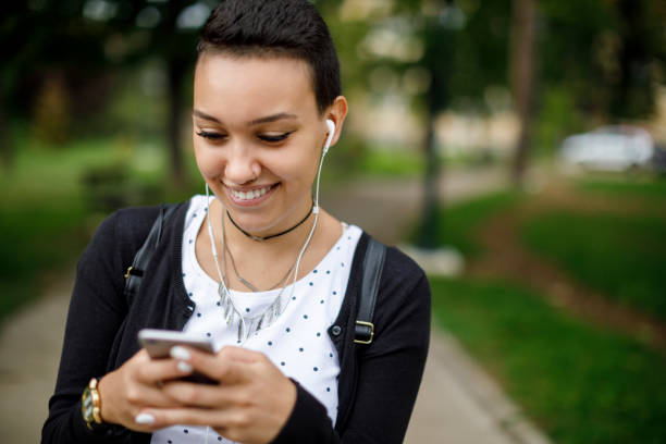istock Young woman using mobile phone outdoors 1139145337