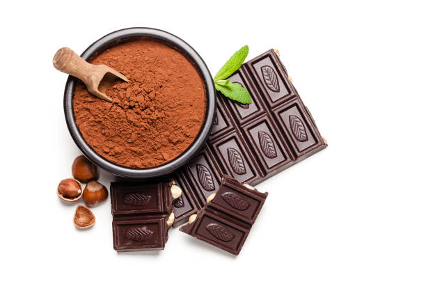 istock Cocoa powder, chocolate bar and hazelnuts shot from above on white background 1139146319