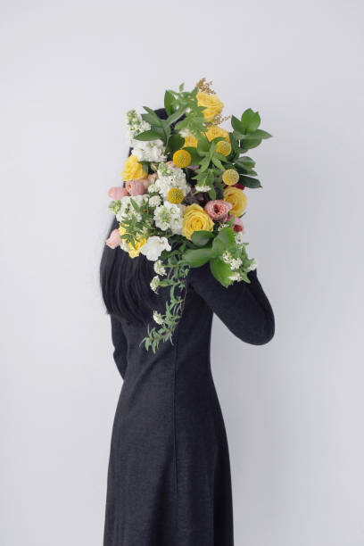 istock woman holding flower bouquet 1139147619