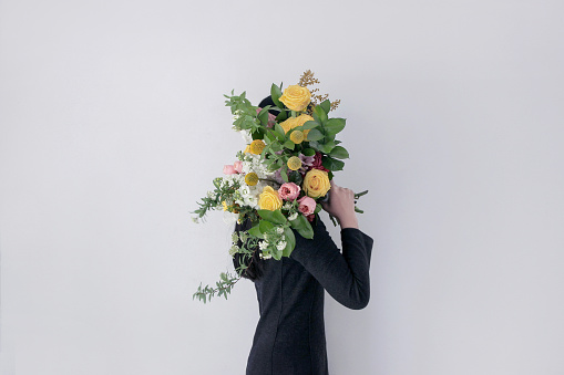 woman holding flower bouquet