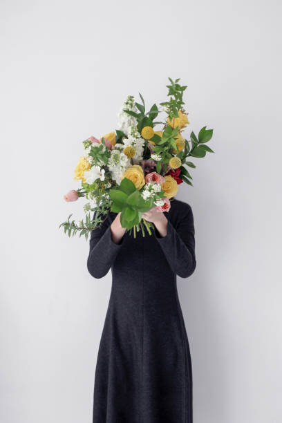istock woman holding flower bouquet 1139147704