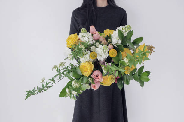 istock woman holding flower bouquet 1139147778