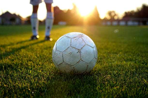 istock penalty kick training with a used ball in the sunset 1139149966