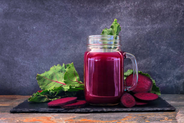 istock Beet juice in a mason jar on a slate platter over a dark background 1139150227